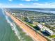 Breathtaking aerial view of a coastal city featuring pristine beaches, serene waterways, and vibrant residential neighborhoods at 7 Marden Dr, Ormond Beach, FL 32176