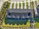 Overhead view of condo community with manicured grounds, lush landscaping, and well-maintained roofs at 7 Marden Dr, Ormond Beach, FL 32176