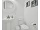 Bathroom featuring a white pedestal sink and a toilet, decorated with seahorse art at 7 Marden Dr, Ormond Beach, FL 32176