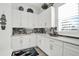 Beautiful butler's pantry with white cabinets, gray countertops, and a charming nautical theme at 7 Marden Dr, Ormond Beach, FL 32176