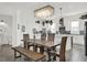 Bright dining area with elegant shell chandelier and rustic wood table, blending coastal charm with modern design at 7 Marden Dr, Ormond Beach, FL 32176