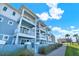Beautiful light-blue exterior with white trim and multiple balconies near palm trees at 7 Marden Dr, Ormond Beach, FL 32176