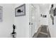 Bright hallway with tile floors, white walls and doors and decorative nautical art at 7 Marden Dr, Ormond Beach, FL 32176