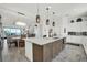 Modern kitchen with island, stylish pendant lights, and open view to the dining and living areas at 7 Marden Dr, Ormond Beach, FL 32176