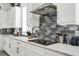 Elegant kitchen showcasing white cabinetry, subway tile, modern appliances, and sleek countertops at 7 Marden Dr, Ormond Beach, FL 32176