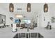 Open-concept living area showcases a kitchen island with elegant marble countertops, pendant lights, and modern appliances at 7 Marden Dr, Ormond Beach, FL 32176