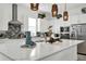 Bright, modern kitchen features white cabinets, gray backsplash, stainless appliances and marble countertops at 7 Marden Dr, Ormond Beach, FL 32176
