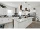 Modern kitchen featuring white cabinetry, subway tile backsplash, stainless steel appliances, and a marble island at 7 Marden Dr, Ormond Beach, FL 32176