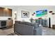 Comfortable living room with a gray sofa, built-in bar, and coastal decor at 7 Marden Dr, Ormond Beach, FL 32176