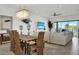 Open-concept living area with beach view, plush seating, capiz chandelier, and unique coastal decor at 7 Marden Dr, Ormond Beach, FL 32176