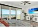 Bright main bedroom featuring ocean views, a tv, ceiling fan and access to the balcony at 7 Marden Dr, Ormond Beach, FL 32176