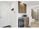 Home wet bar featuring a microwave, wine fridge, and custom cabinets at 7 Marden Dr, Ormond Beach, FL 32176