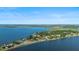 Stunning aerial view of lakefront homes nestled along a peninsula with lush greenery and serene blue waters at 7046 Treasure Island Rd, Leesburg, FL 34788