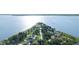 Scenic aerial view of a peninsula with waterfront homes surrounded by a tranquil lake at 7046 Treasure Island Rd, Leesburg, FL 34788