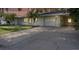 Charming single-story home with a well-maintained lawn, mature trees, and an attached two car garage at 7046 Treasure Island Rd, Leesburg, FL 34788