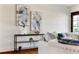 Tastefully decorated living room with contemporary artwork, sleek shelving, and comfortable seating arrangement at 7046 Treasure Island Rd, Leesburg, FL 34788
