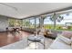 Inviting sunroom with abundant natural light and comfortable seating overlooking scenic waterfront views at 7046 Treasure Island Rd, Leesburg, FL 34788