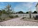 Back yard with brick pavers surrounded by white vinyl fence and lush landscaping at 7407 Country Run Pkwy, Orlando, FL 32818