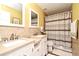 Bathroom with double sinks, tile walls, and a shower-tub combination is both functional and stylish at 7407 Country Run Pkwy, Orlando, FL 32818