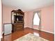Bedroom featuring hardwood floors, a television cabinet, and a window with curtains at 7407 Country Run Pkwy, Orlando, FL 32818