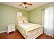 Cozy bedroom with light yellow walls, a ceiling fan, and a comfortable bed with matching pillows and shams at 7407 Country Run Pkwy, Orlando, FL 32818