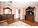 Bedroom featuring hardwood floors, a wooden dresser with mirror, and a television cabinet at 7407 Country Run Pkwy, Orlando, FL 32818