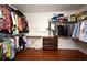 Spacious walk-in closet with custom shelving, hardwood floors, and an ironing board at 7407 Country Run Pkwy, Orlando, FL 32818