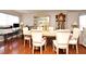 Spacious dining room with hardwood floors, six chairs, and an elegant china cabinet at 7407 Country Run Pkwy, Orlando, FL 32818