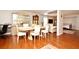 Open dining room area with view of a bedroom, Gathering room, and wood flooring at 7407 Country Run Pkwy, Orlando, FL 32818