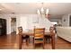 Dining area with wood table and chairs next to laundry room and entrance to the staircase at 7407 Country Run Pkwy, Orlando, FL 32818