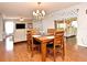 Dining area with wood table and chairs next to the main Gathering room area at 7407 Country Run Pkwy, Orlando, FL 32818