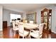 Formal dining room features wood floors, elegant furniture, and decorative display cases at 7407 Country Run Pkwy, Orlando, FL 32818