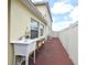 Exterior view of home showing a utility sink area and access to the fenced-in backyard at 7407 Country Run Pkwy, Orlando, FL 32818