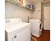 Well-equipped laundry room featuring modern washer and dryer units, and convenient shelving for storage at 7407 Country Run Pkwy, Orlando, FL 32818