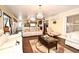 Open-concept living room and kitchen with modern lighting and hardwood floors at 7407 Country Run Pkwy, Orlando, FL 32818