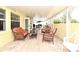 Covered patio with tile flooring, wicker furniture and lots of seating, great for outdoor entertainment at 7407 Country Run Pkwy, Orlando, FL 32818
