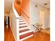 Stairway with wood stairs and a glass-topped table at 7407 Country Run Pkwy, Orlando, FL 32818