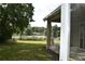 Inviting covered patio with seating and scenic lake views through the window at 7508 Lake Marsha Dr, Orlando, FL 32819