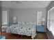 Bright bedroom featuring wood floors, ample natural light, and decorative blue bedside tables with lamps at 7508 Lake Marsha Dr, Orlando, FL 32819