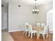 Elegant dining room featuring a glass table, chandelier, and ample natural light at 7508 Lake Marsha Dr, Orlando, FL 32819