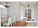 Charming dining room with a glass table and a view into the light-filled living room at 7508 Lake Marsha Dr, Orlando, FL 32819