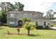 Charming two-story home with lush landscaping and a well-manicured lawn at 7508 Lake Marsha Dr, Orlando, FL 32819