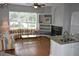 Cozy living room with a fireplace, built-in shelving, and a view of the lake at 7508 Lake Marsha Dr, Orlando, FL 32819