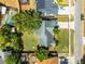 Aerial view of the property showing the roof, backyard, and surrounding neighborhood with red property outline at 8004 Village Green Rd, Orlando, FL 32818