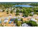 Aerial view of the neighborhood, showcasing the property's location near a lake and green spaces with red property outline at 8004 Village Green Rd, Orlando, FL 32818