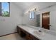 Bathroom featuring double sinks, a large mirror, and plenty of counter space at 8004 Village Green Rd, Orlando, FL 32818