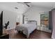 Bedroom featuring two windows, wood floor, and high ceiling at 8004 Village Green Rd, Orlando, FL 32818