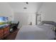 Cozy bedroom featuring a comfortable bed, desk, and TV, illuminated by natural light from the window at 8004 Village Green Rd, Orlando, FL 32818