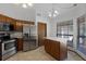 Bright kitchen with wood cabinets, stainless steel appliances, and center island at 8004 Village Green Rd, Orlando, FL 32818