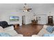 Bright and open living room with hardwood floors, vaulted ceilings, and a ceiling fan for added comfort at 8004 Village Green Rd, Orlando, FL 32818
